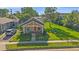 Charming bungalow with a red front door, beautiful lawn, and inviting front porch seating at 5614 Yarrow St, Arvada, CO 80002