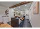 Open kitchen with a dark countertop island, white cabinets, and hardwood floors for modern appeal at 5614 Yarrow St, Arvada, CO 80002