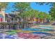 Outdoor dining area with colorful street murals, lush plants, and shaded seating creates a lively atmosphere at 5614 Yarrow St, Arvada, CO 80002