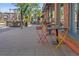 Outdoor dining area featuring colorful chairs creating an inviting atmosphere on a classic brick sidewalk at 5614 Yarrow St, Arvada, CO 80002