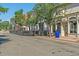 Street view of local stores with outdoor dining, including shade cover, and lush hanging plants at 5614 Yarrow St, Arvada, CO 80002
