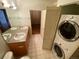 Bathroom with double vanity and in-unit laundry at 2960 Inca St # 319, Denver, CO 80202