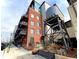 Brick building exterior with balcony and water tower at 2960 Inca St # 319, Denver, CO 80202