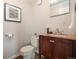 Small bathroom with granite vanity and wood cabinet at 16587 W 53Rd Way, Golden, CO 80403