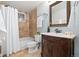 Clean bathroom with tan tile, a vanity, and a bathtub at 16587 W 53Rd Way, Golden, CO 80403