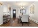 Bright dining room features a wood table, chandelier, and hardwood floors at 16587 W 53Rd Way, Golden, CO 80403