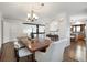 Open concept dining room with a large wooden table and kitchen views at 16587 W 53Rd Way, Golden, CO 80403