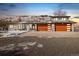 House exterior with three car garage and snowy yard at 16587 W 53Rd Way, Golden, CO 80403