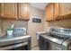 Laundry room with washer, dryer, and wood cabinets at 16587 W 53Rd Way, Golden, CO 80403