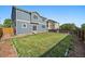Spacious backyard with a well-maintained lawn and a wooden fence, perfect for outdoor activities at 2404 S Genoa Way, Aurora, CO 80013