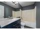 Well-lit bathroom featuring a vanity with a large mirror and a shower-tub combo with tile surround at 2404 S Genoa Way, Aurora, CO 80013