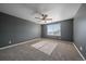 Spacious bedroom with neutral carpet, ceiling fan, and a sun-filled window, offering a relaxing retreat at 2404 S Genoa Way, Aurora, CO 80013