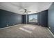 Comfortable bedroom with neutral carpeting and a bright window, perfect for rest and relaxation at 2404 S Genoa Way, Aurora, CO 80013