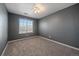 Light-filled bedroom with plush carpeting and a window, offering a tranquil and comfortable space at 2404 S Genoa Way, Aurora, CO 80013