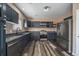 Well-equipped kitchen with stainless steel appliances, granite countertops, and a modern faucet at 2404 S Genoa Way, Aurora, CO 80013
