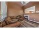 Comfortable living room featuring hardwood floors, fireplace, and large windows at 2404 S Genoa Way, Aurora, CO 80013