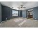 Inviting main bedroom with carpet and natural light leading to the bathroom with a double sink vanity at 2404 S Genoa Way, Aurora, CO 80013