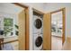 Laundry closet with a stackable washer and dryer and wood-trimmed door at 4632 14Th St, Boulder, CO 80304