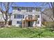 Two story home featuring a composite deck overlooking a lush green backyard with stairs leading down at 9265 Roadrunner St, Highlands Ranch, CO 80129
