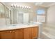 Spacious bathroom with dual sinks, a large mirror, and a separate soaking tub at 9265 Roadrunner St, Highlands Ranch, CO 80129