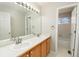 Bathroom features a double sink vanity, a large mirror, and a separate door leading to the shower and toilet at 9265 Roadrunner St, Highlands Ranch, CO 80129