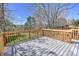 A spacious deck is made of composite material with wood railings and a view of the yard at 9265 Roadrunner St, Highlands Ranch, CO 80129
