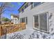 Back of house featuring a gray composite deck with wood railings and a door leading to inside the home at 9265 Roadrunner St, Highlands Ranch, CO 80129