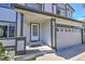 Close up view of the inviting front entrance with well maintained garage door and number 9265 at 9265 Roadrunner St, Highlands Ranch, CO 80129
