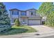 Inviting two-story home with a well-maintained lawn and an attached two-car garage at 9265 Roadrunner St, Highlands Ranch, CO 80129
