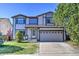 Charming two-story home featuring a well-manicured lawn and a convenient two-car garage at 9265 Roadrunner St, Highlands Ranch, CO 80129