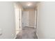 A hallway is carpeted and painted a neutral color with multiple doorways leading to other rooms at 9265 Roadrunner St, Highlands Ranch, CO 80129