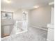 Hallway leading to carpeted rooms, features natural light through windows at 9265 Roadrunner St, Highlands Ranch, CO 80129