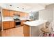 Well-lit kitchen featuring light wood cabinets, modern stainless steel appliances, and breakfast bar at 9265 Roadrunner St, Highlands Ranch, CO 80129
