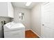 Bright laundry room featuring modern appliances, and tile flooring at 9265 Roadrunner St, Highlands Ranch, CO 80129
