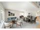 Staged open-concept living room and dining area bathed in natural light at 9265 Roadrunner St, Highlands Ranch, CO 80129