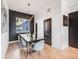 Dining room featuring a dark accent wall, modern lighting, and stylish chairs around a wooden table at 2602 W 24Th Ave # 6, Denver, CO 80211