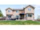 Two-story home featuring a well-manicured backyard with patio and outdoor seating areas at 17378 W 78Th Dr, Arvada, CO 80007