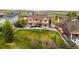 Spacious backyard with large grassy area, fence, patio with BBQ, and outdoor seating perfect for entertaining and relaxing at 17378 W 78Th Dr, Arvada, CO 80007
