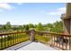 Balcony view of a neighborhood with green spaces, trees, and distant mountains under a blue sky at 17378 W 78Th Dr, Arvada, CO 80007