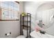 Stylish half bathroom with vessel sink, modern fixtures, and charming decor at 17378 W 78Th Dr, Arvada, CO 80007
