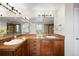 Bathroom featuring a double vanity with granite countertops and modern lighting at 17378 W 78Th Dr, Arvada, CO 80007