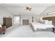 Large bedroom suite with neutral walls, carpeted floor, and an attached sitting area at 17378 W 78Th Dr, Arvada, CO 80007