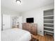 Bright bedroom with hardwood floors, ensuite bathroom and built in shelves at 17378 W 78Th Dr, Arvada, CO 80007