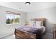 Cozy bedroom with a large window offering outdoor views and plenty of natural light at 17378 W 78Th Dr, Arvada, CO 80007