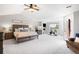 Spacious main bedroom featuring a fireplace, sitting area, and access to a private balcony at 17378 W 78Th Dr, Arvada, CO 80007
