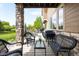 Relaxing covered patio with stone columns and outdoor seating perfect for dining and entertaining at 17378 W 78Th Dr, Arvada, CO 80007