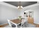 Bright dining room features a modern chandelier, gray ceiling and hardwood floors at 17378 W 78Th Dr, Arvada, CO 80007
