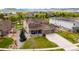 Charming two-story home featuring a well-manicured front lawn, an attached three-car garage, and stone accents on the facade at 17378 W 78Th Dr, Arvada, CO 80007