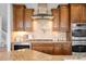 Close-up of a kitchen featuring a gas range, granite countertops, stainless steel appliances, and custom cabinetry at 17378 W 78Th Dr, Arvada, CO 80007