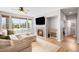 Comfortable living room boasts a cozy fireplace, and many windows for natural light at 17378 W 78Th Dr, Arvada, CO 80007